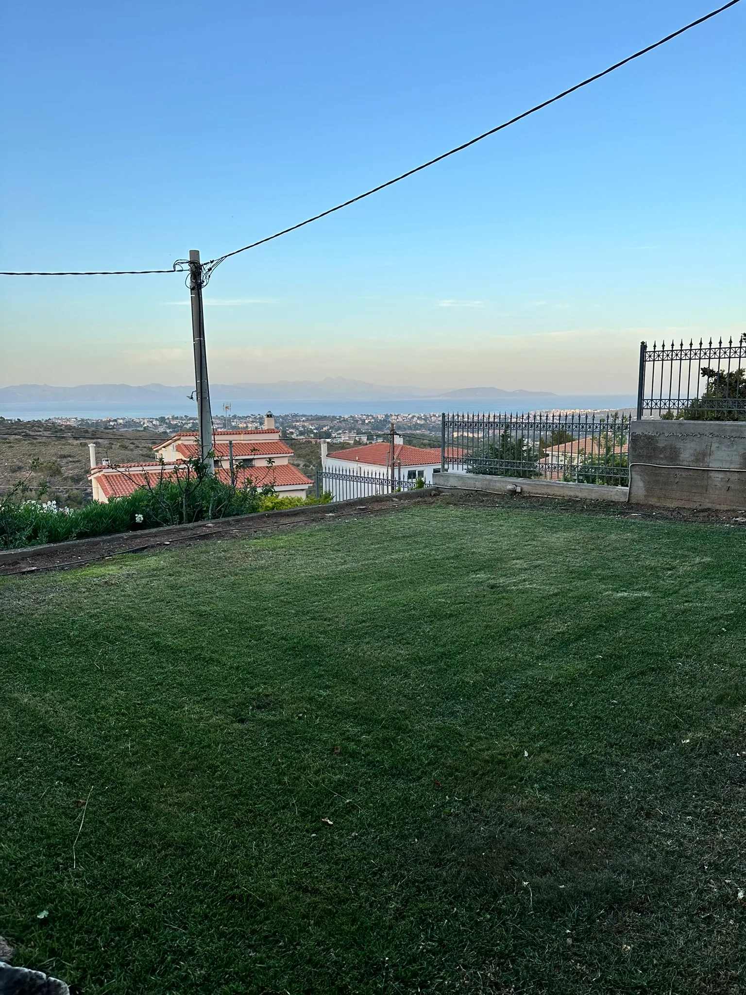 Aegean Hill Retreat exterior view across Rafina and the Aegean.