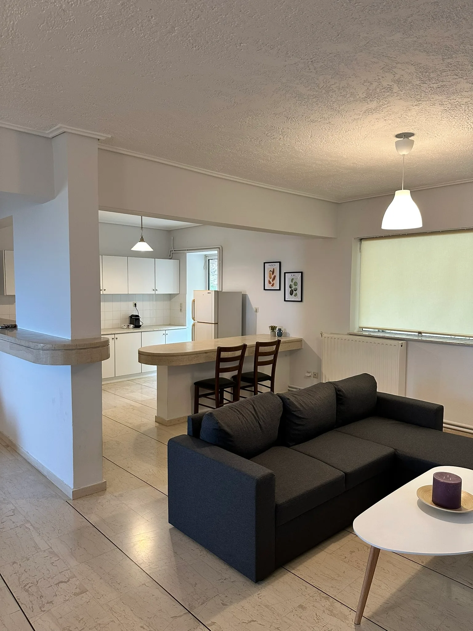 Aegean Hill Retreat open-plan living room and kitchen area.