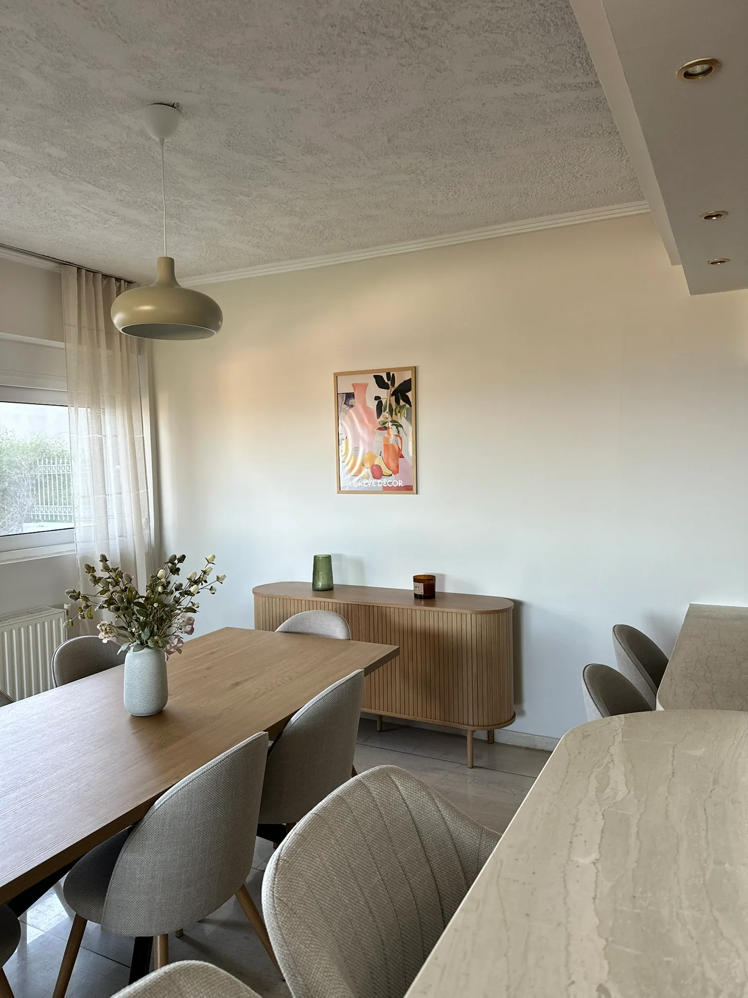 Aegean Hill SkyView dining area with warm neutral finishes.