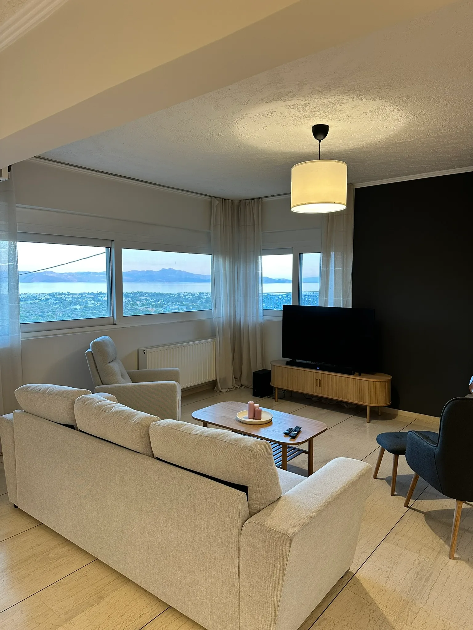 Aegean Hill SkyView living room with sea-facing windows.