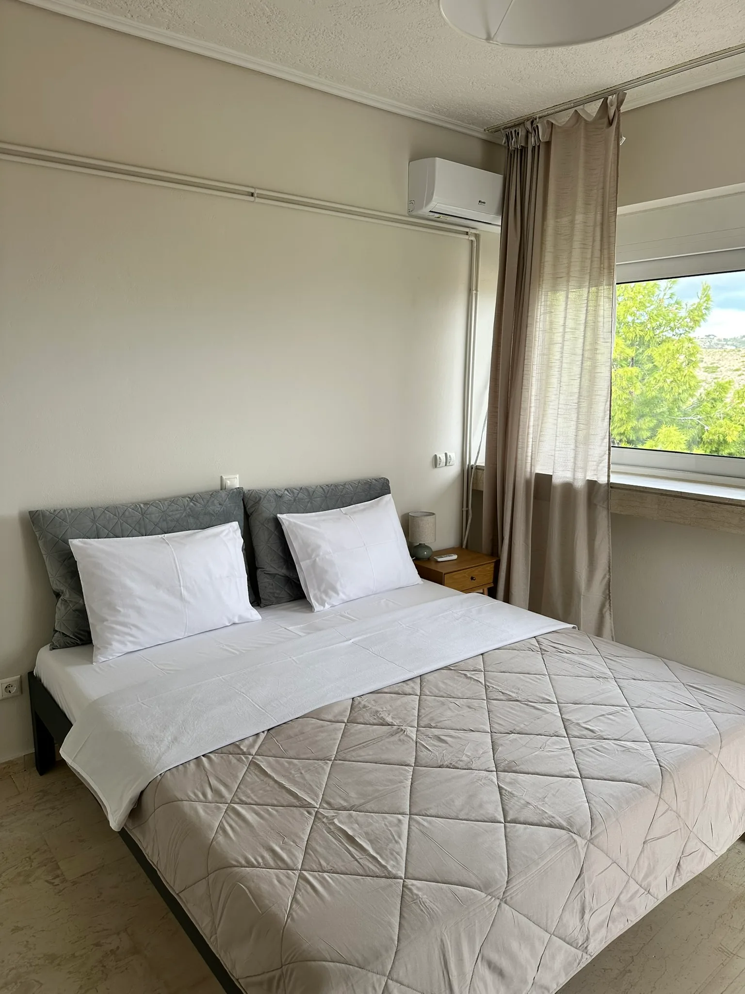 Aegean Hill SkyView bedroom with double bed and natural light.